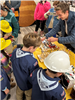An employee guides cub scout members in a model grid demonstration.